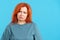 Mature redheaded woman looking at camera with sad expression