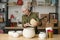 Mature retired female gardener holding decorated flowerpot over larger vase