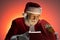 Mature Santa Claus looking inside opened gift box