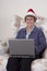 Mature Senior Woman Christmas Laptop Santa Hat