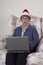 Mature Senior Woman Christmas Laptop Santa Hat