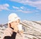 Mature smiling woman drinking a tea and posing outside in snowy