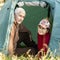 Mature sports couple resting in nature in a tent in love and harmony