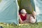 Mature sports couple resting in nature in a tent in love and harmony