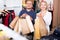 Mature spouses carrying bags with purchases