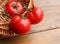 Mature tomatoes on a wicker basket background