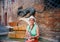 Mature tourist woman sitting at fountain with monument of panther