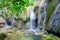 Mature trees and milky falls at Thac Voi waterfall, Thanh Hoa, Vietnam