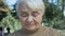 Mature unhappy woman crying outdoors, old age problems, loneliness despair