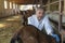 Mature Veterinarian Examining a Goat With Stethoscope at Goat Farm