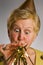 Mature woman blowing party horn