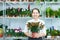 Mature woman with citrus plant in store