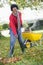 Mature woman collecting leaves in garden