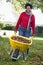 Mature woman collecting leaves in garden