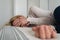 Mature woman curled lying on the bed at home top view. Depression, mental health, abuse problem