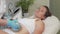 Mature woman enjoying endospheres hardware massage at beauty clinic