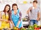 Mature woman with family preparing at kitchen.