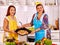 Mature woman with family preparing at kitchen