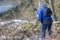 Mature woman filming with her mobile phone gimbal tripod head stabilizer wild vegetation and snow