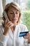 Mature Woman Giving Credit Card Details On The Phone