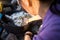 Mature Woman Grilling Food In Firepit At Forest