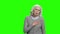 Mature woman having heart ache on green screen.