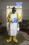 Mature woman in Haz Mat suit with blue broom and dust pan