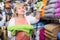 Mature woman holding cotton colour towel in the textile shop