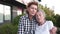 Mature woman hugging, talking with senior female, sitting on bench in city square. Elderly daughter visits, spends time