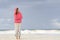 Mature woman keeping warm at beach