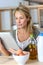 Mature woman in the kitchen looking for recipe