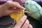 Mature woman knitting warm sweater at table, closeup