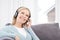 Mature Woman Listening To Music On Wireless Headphones