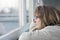 Mature woman looking out the window on a rainy day