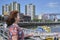 Mature woman looking towards the Riachuelo, in La Boca, Buenos Aires, Argentina