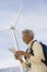 Mature Woman With Map By Wind Farm