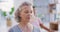 Mature woman meditating with eyes closed during a group fitness class in a yoga studio. Face of a calm, relaxed and