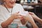 Mature woman meeting her senior mother at the coffee shop