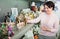 Mature woman near souvenirs shelves