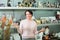 Mature woman near souvenirs shelves