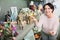 Mature woman near souvenirs shelves