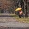 Mature woman in the park with umbrella