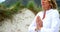 Mature woman performing yoga at beach