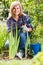 Mature woman planting lily in garden