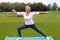 Mature woman practicing yoga in the park