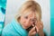 Mature woman putting on mascara