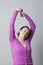Mature woman raising arms to relax her sore muscles