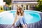 Mature woman relaxing on the poolside at home