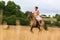 Mature woman riding an Andalusian horse