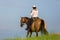 Mature woman riding an Andalusian horse